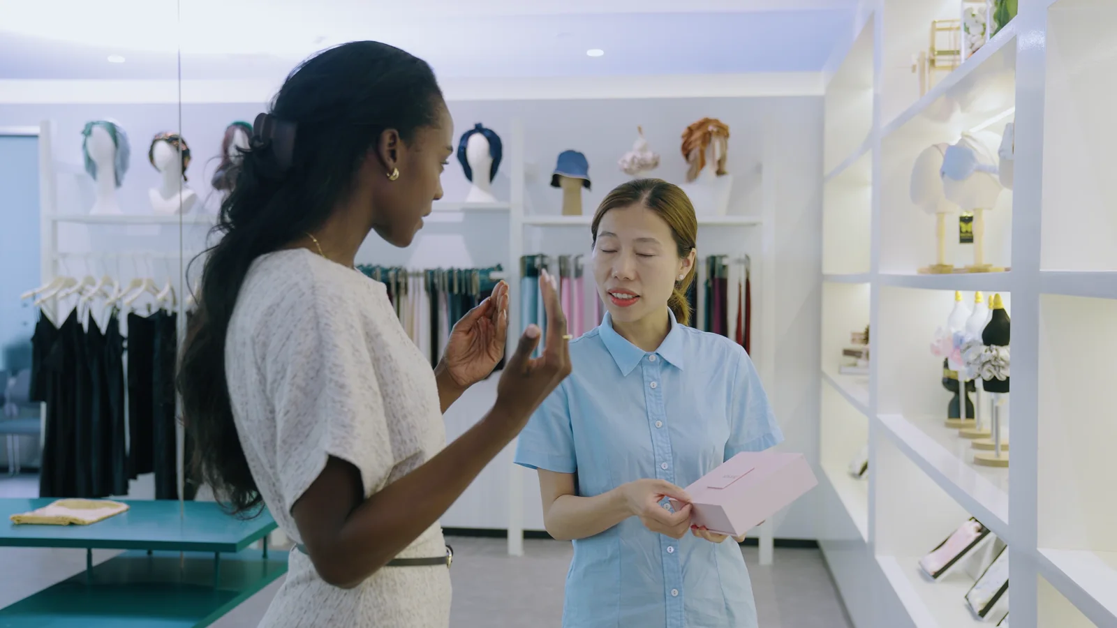 Stitch Silk team member discussing product options with a buyer in the showroom