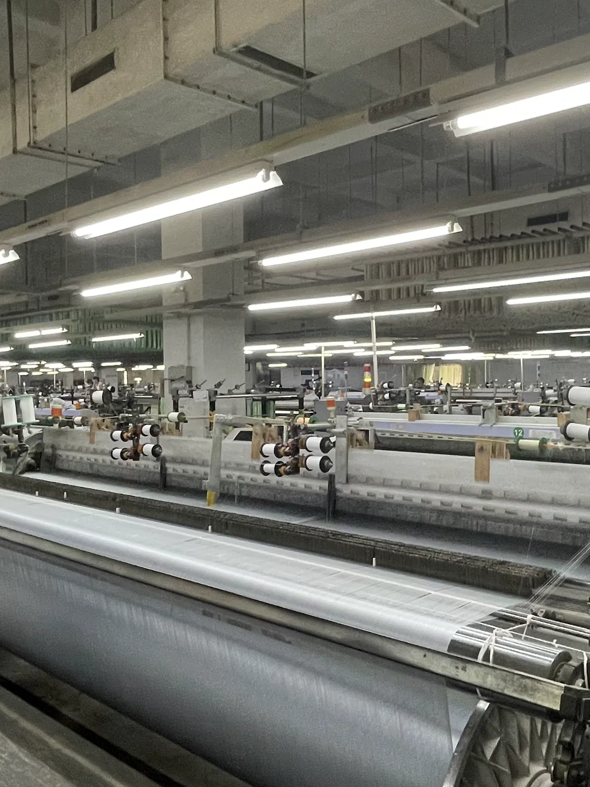 Silk fabric weaving equipment operating inside the production facility