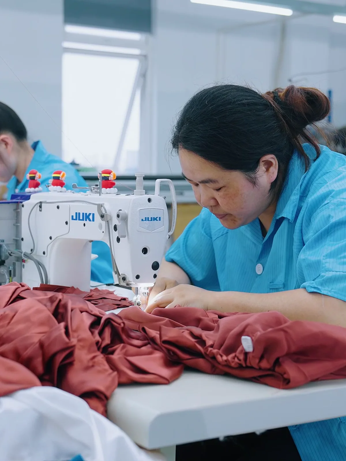 Stitch Silk sewing specialist working on a silk garment