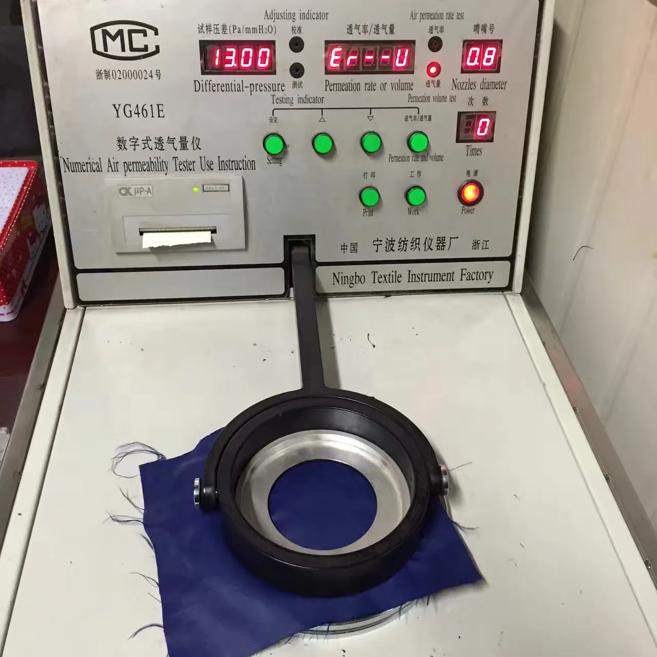 Silk fabric sample undergoing an air permeability test
