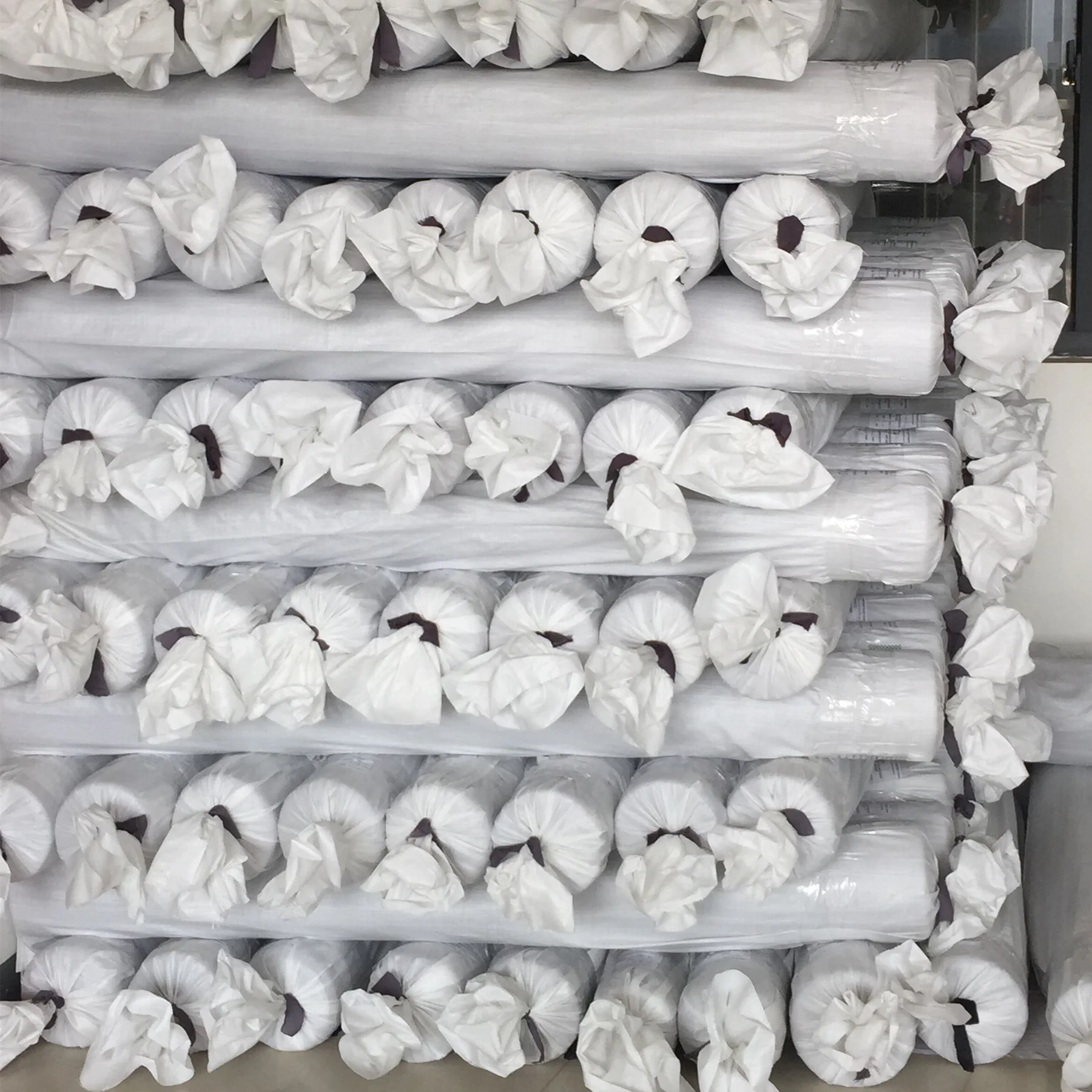 Silk fabric rolls protected with individual wrapping before shipment