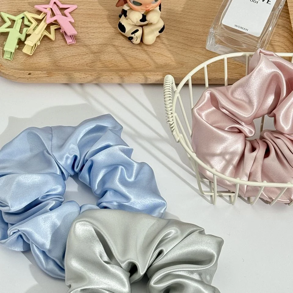 Close view of pastel silk scrunchie fabric and gathers