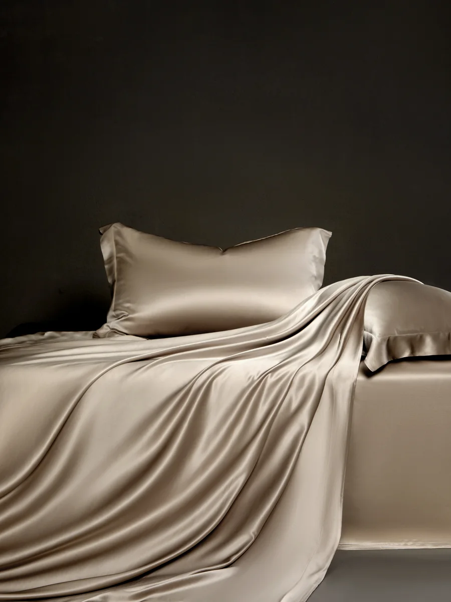 Champagne silk bedding showing the duvet cover draped over the edge of the bed