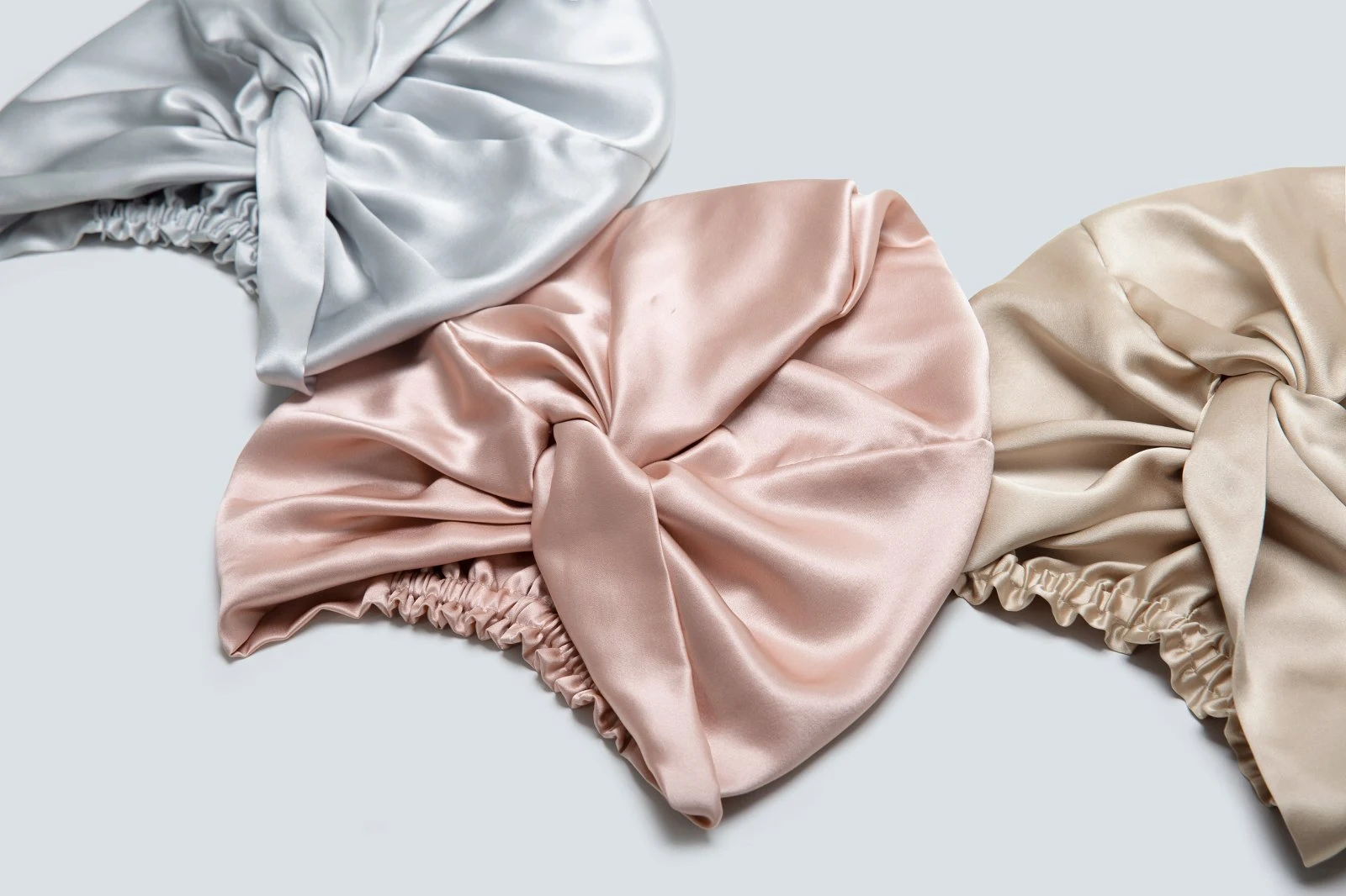 Silver, blush, and champagne silk bow bonnets showing different cap-volume options