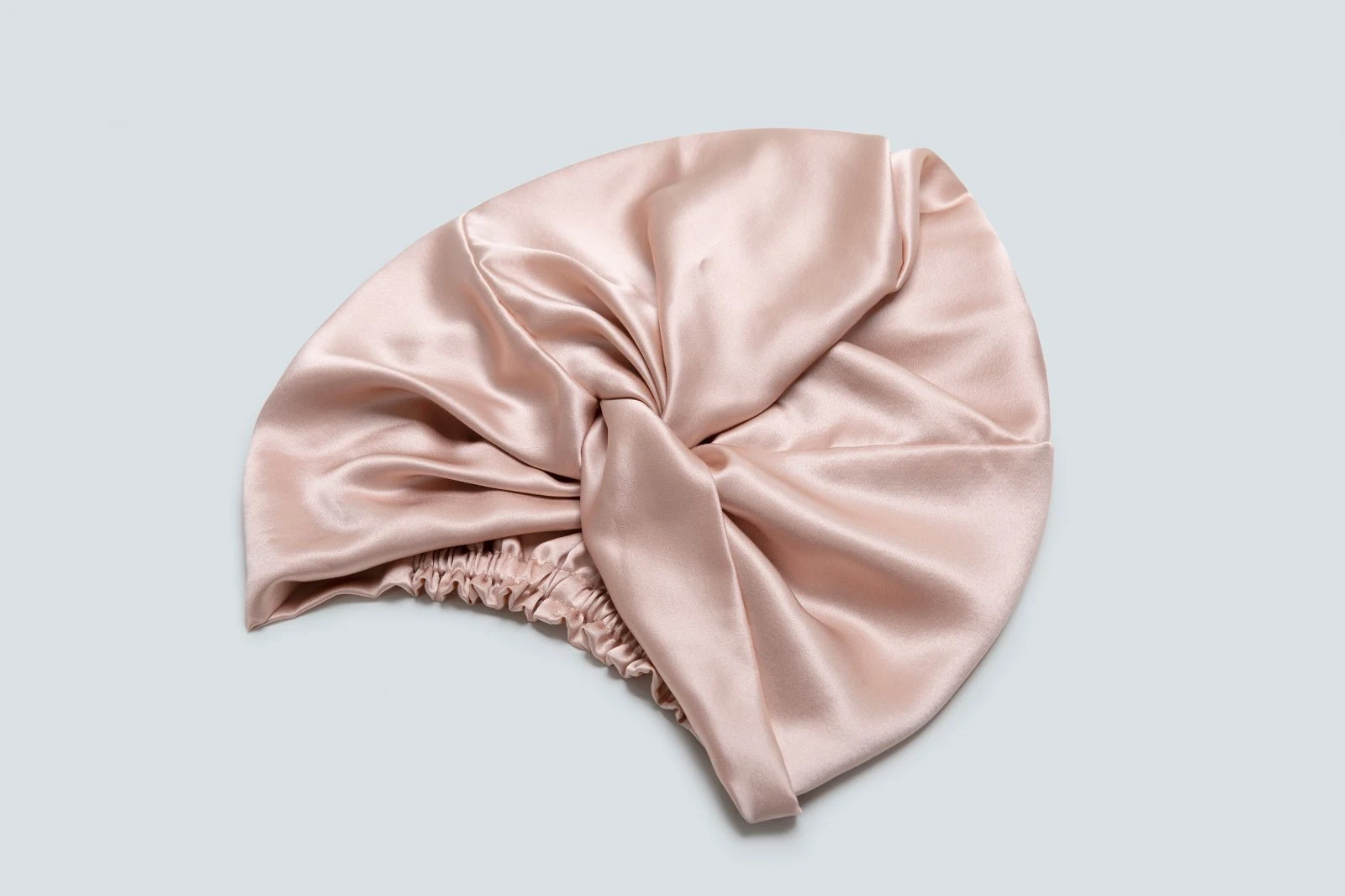 Blush silk bow bonnet shown flat for construction inspection