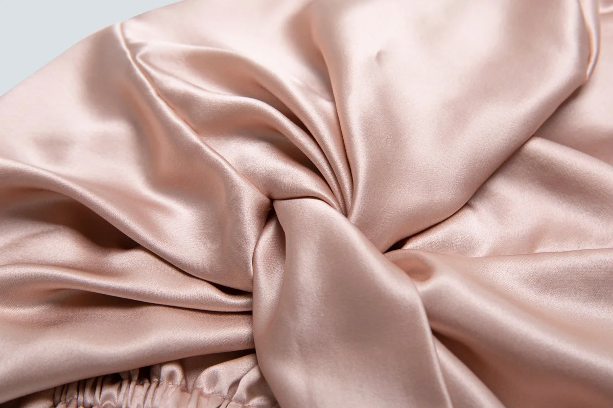 Close-up of a blush silk bonnet bow and fabric finish