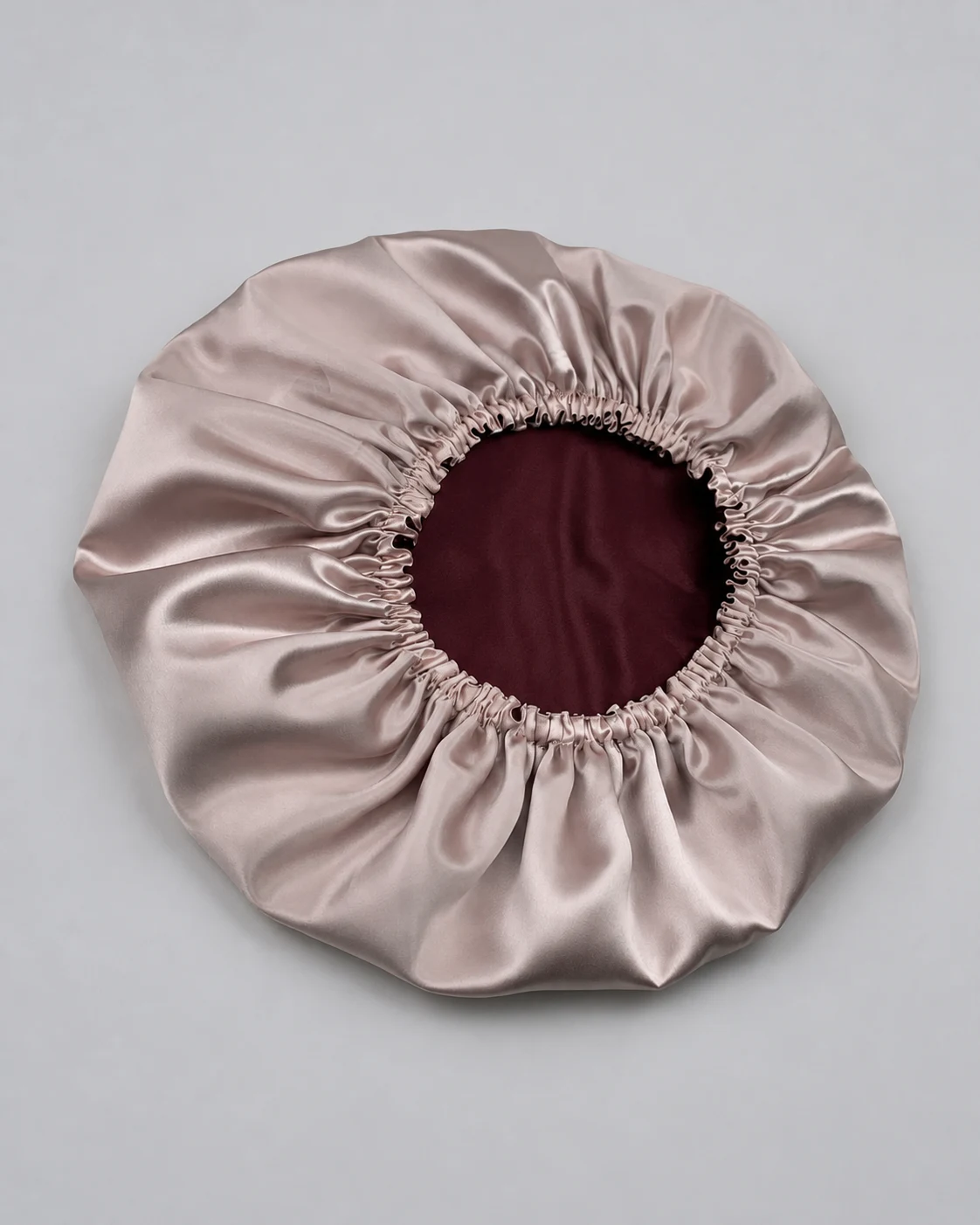 Double-layer silk bonnet opened to show its inner and outer silk surfaces