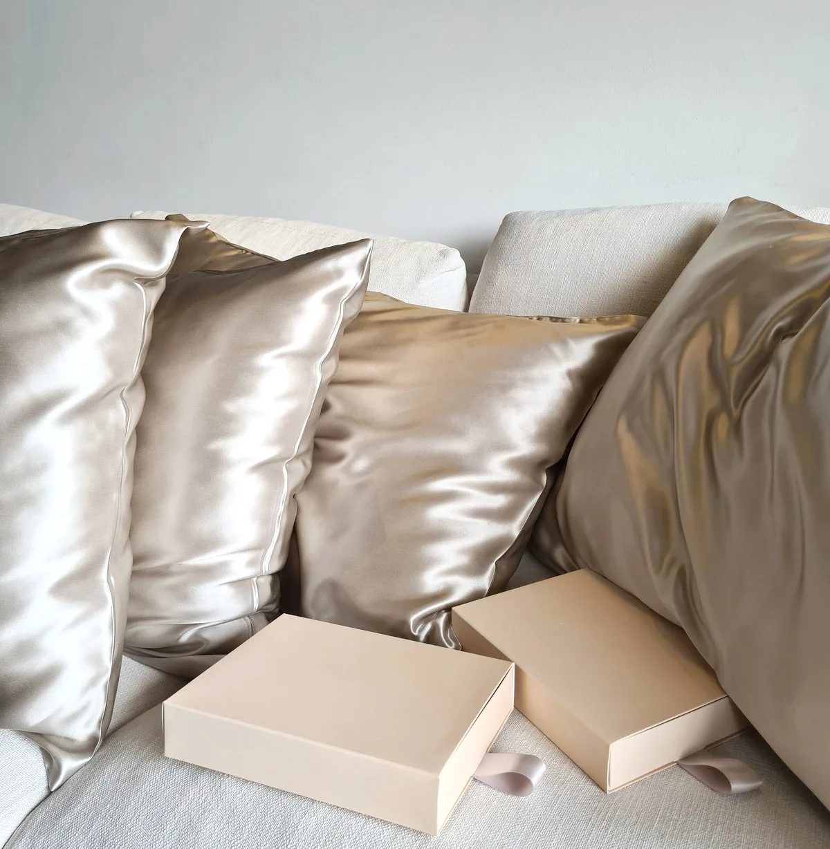 Silk pillowcases arranged with retail gift boxes