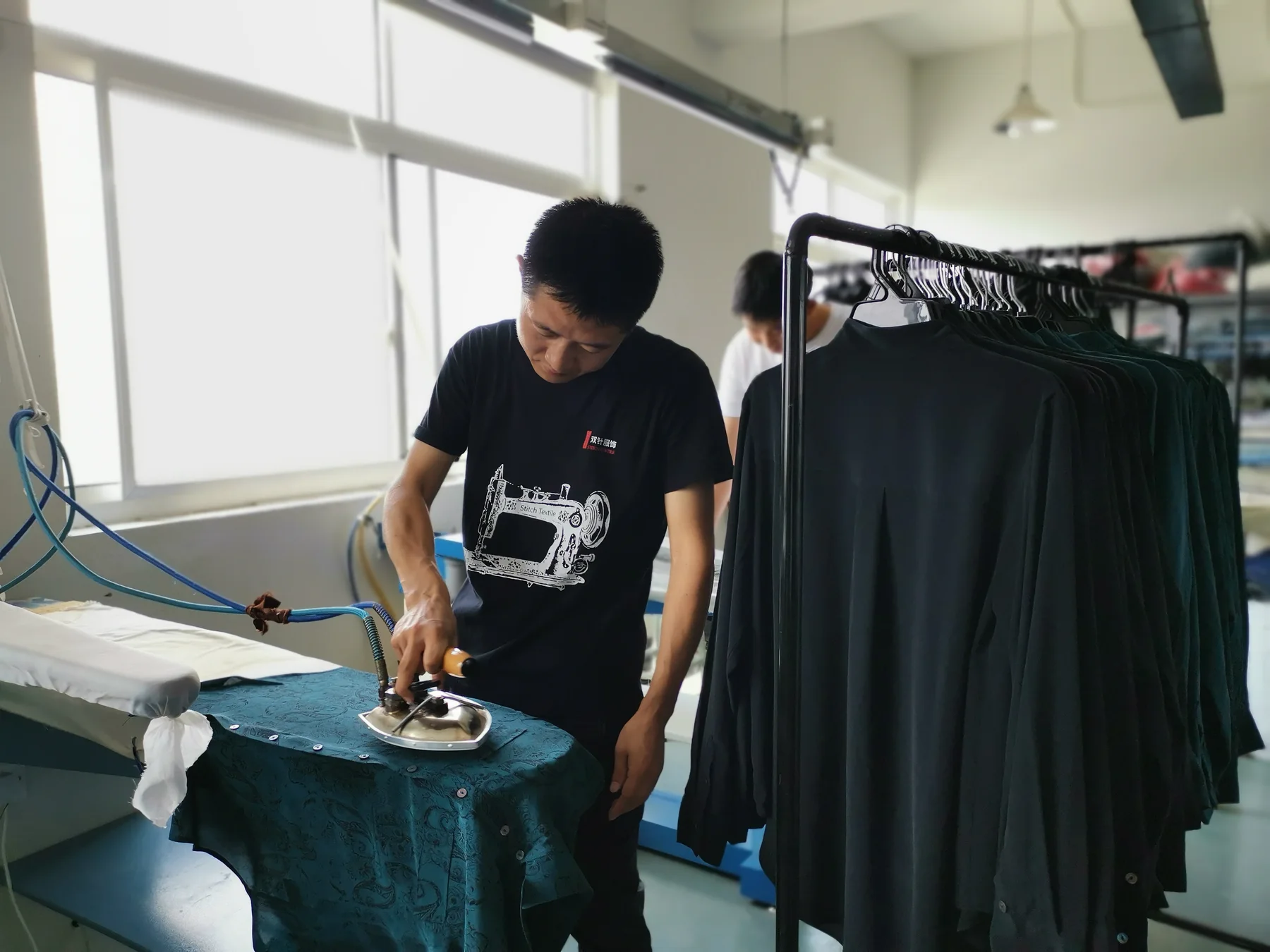 Garment pressing and shape setting during sleepwear production