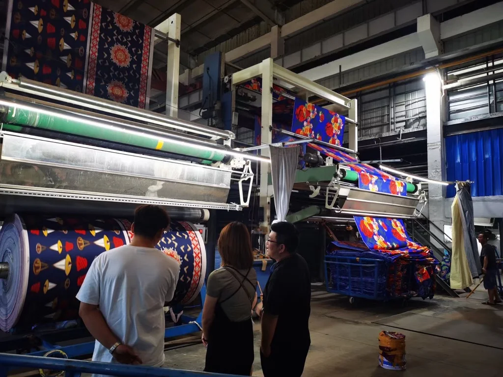 Roller printing in progress for colorful patterned fabric